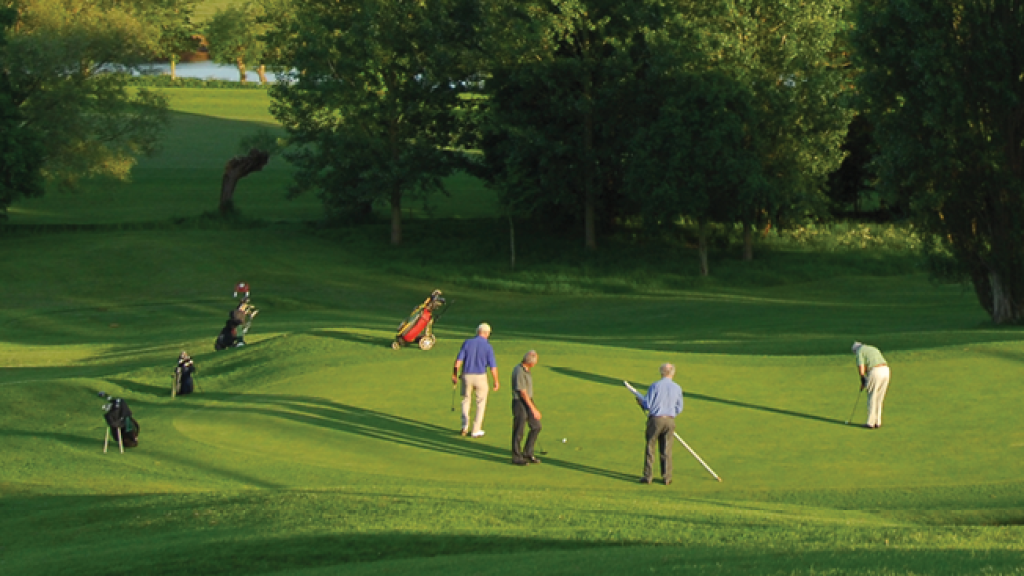 Golfers walking on golf course